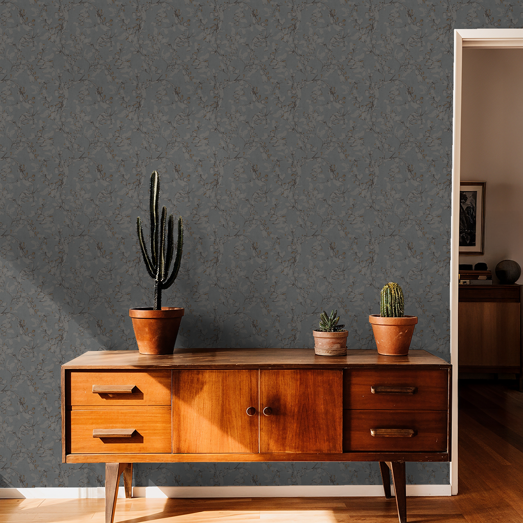 Navy floral vine wallpaper in a mid-century modern living room with cacti decor.