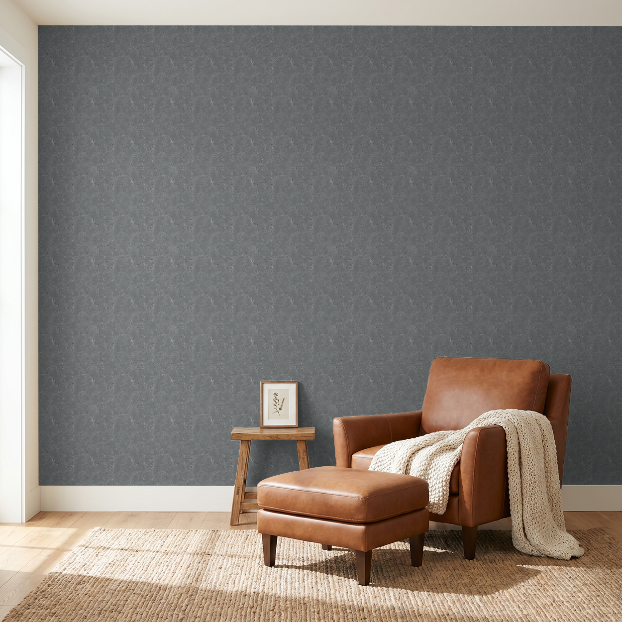 Navy floral vine wallpaper in a modern living room with brown leather chair.