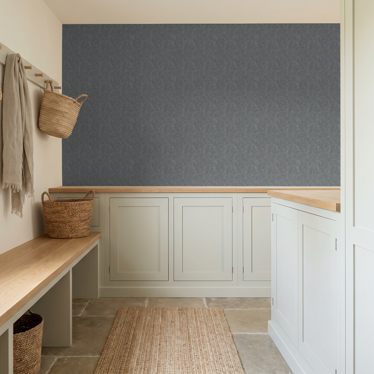Navy floral vine wallpaper in a modern mudroom with light cabinets and natural decor.