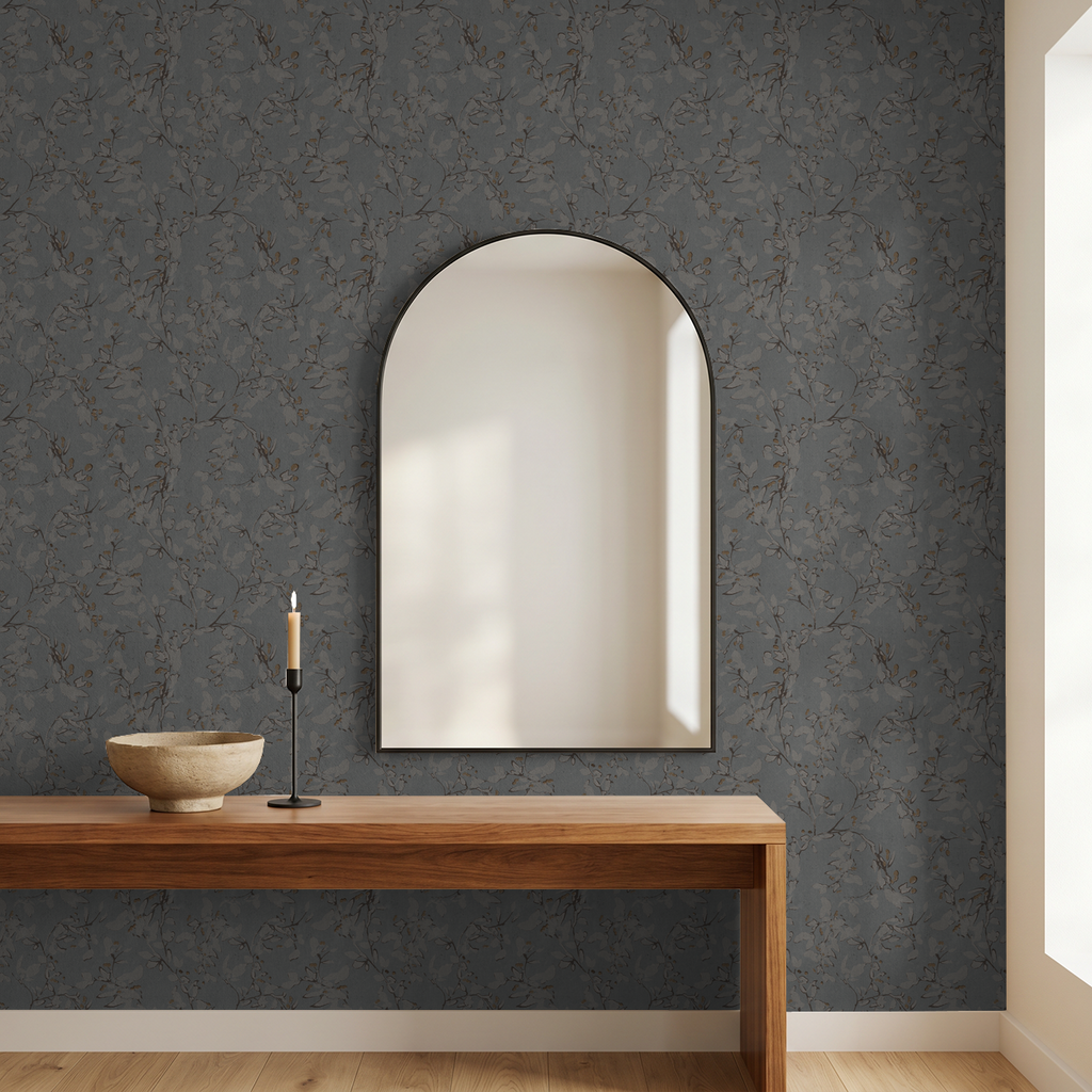Navy floral vine wallpaper in modern room with wooden console and mirror.