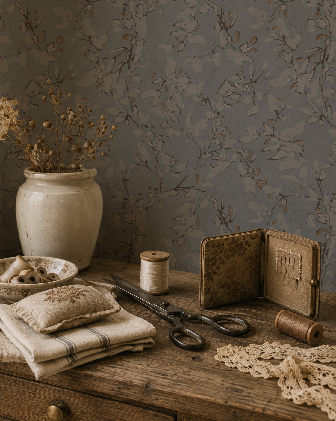 Navy floral vine wallpaper with vintage decor on a wooden table.