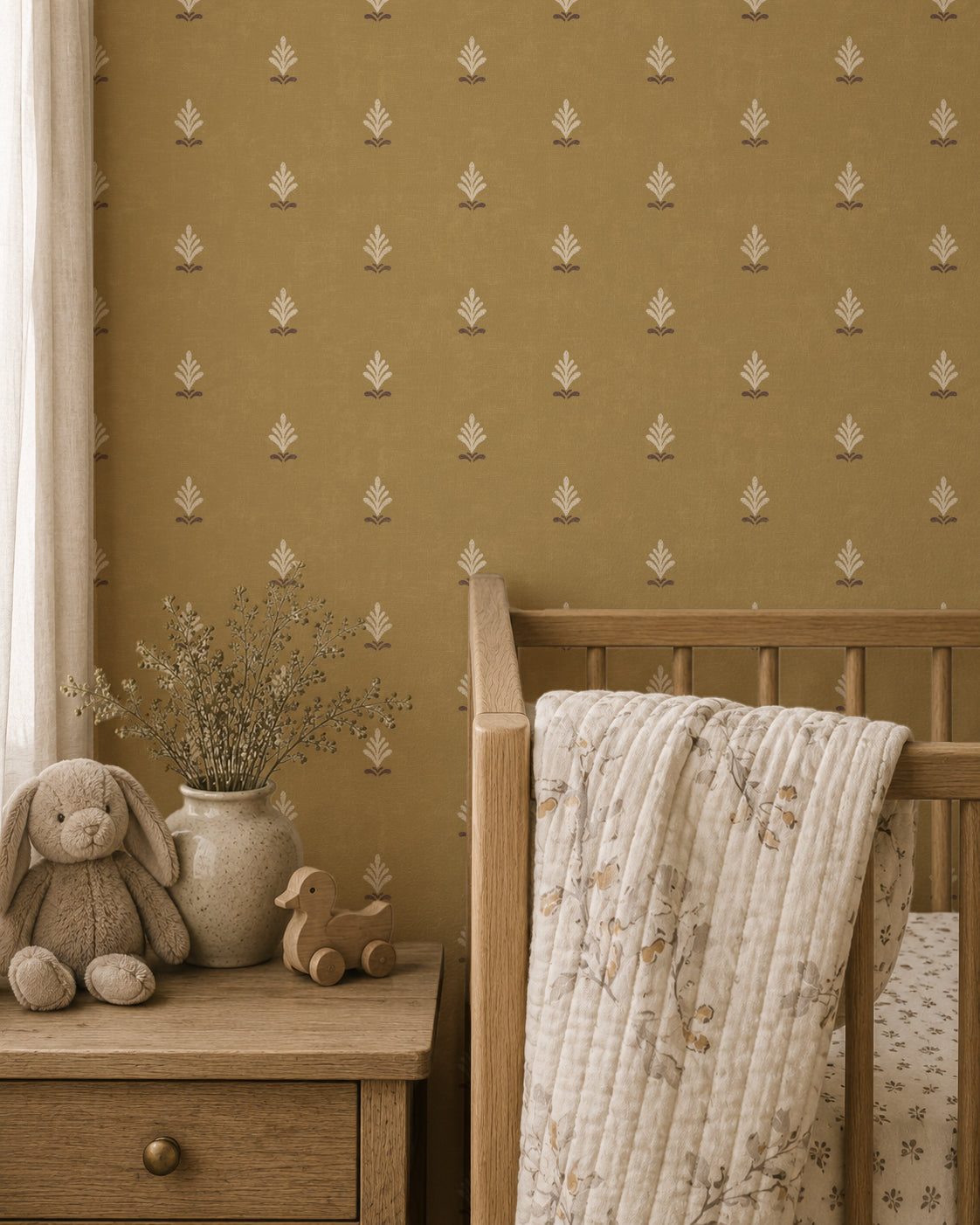 Ochre wallpaper with cream motifs in a cozy nursery setting.
