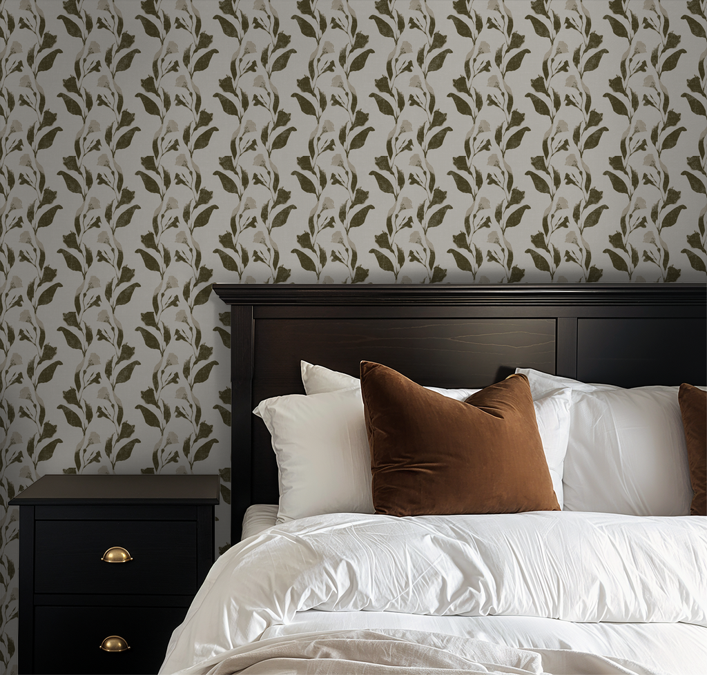 Olive botanical vine wallpaper in bedroom with dark wood bed and white bedding.