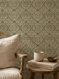 Ornate damask wallpaper in sage and cream with rustic decor setting.