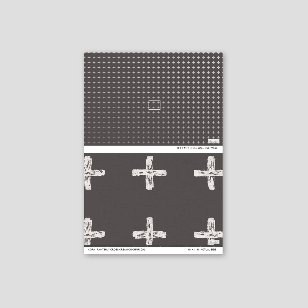 Painterly cross cream on charcoal wallpaper with bold geometric pattern.