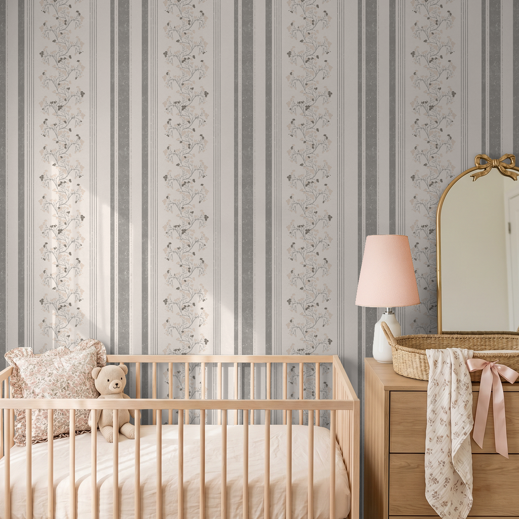 Pink slate floral stripe wallpaper in a cozy nursery with crib and dresser.