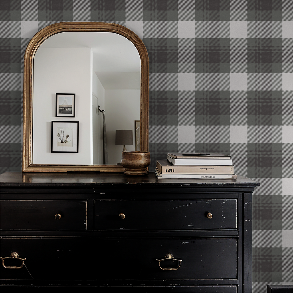 Plaid grey and charcoal wallpaper in a classic room with a vintage mirror and black dresser.