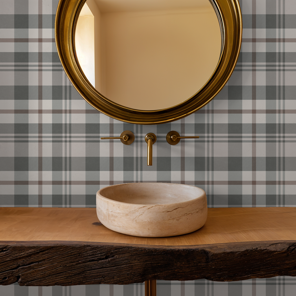 Plaid wallpaper in cream and green with round mirror and wooden sink.