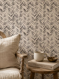 Rustic chevron wallpaper in cream and charcoal with chair and table setting.