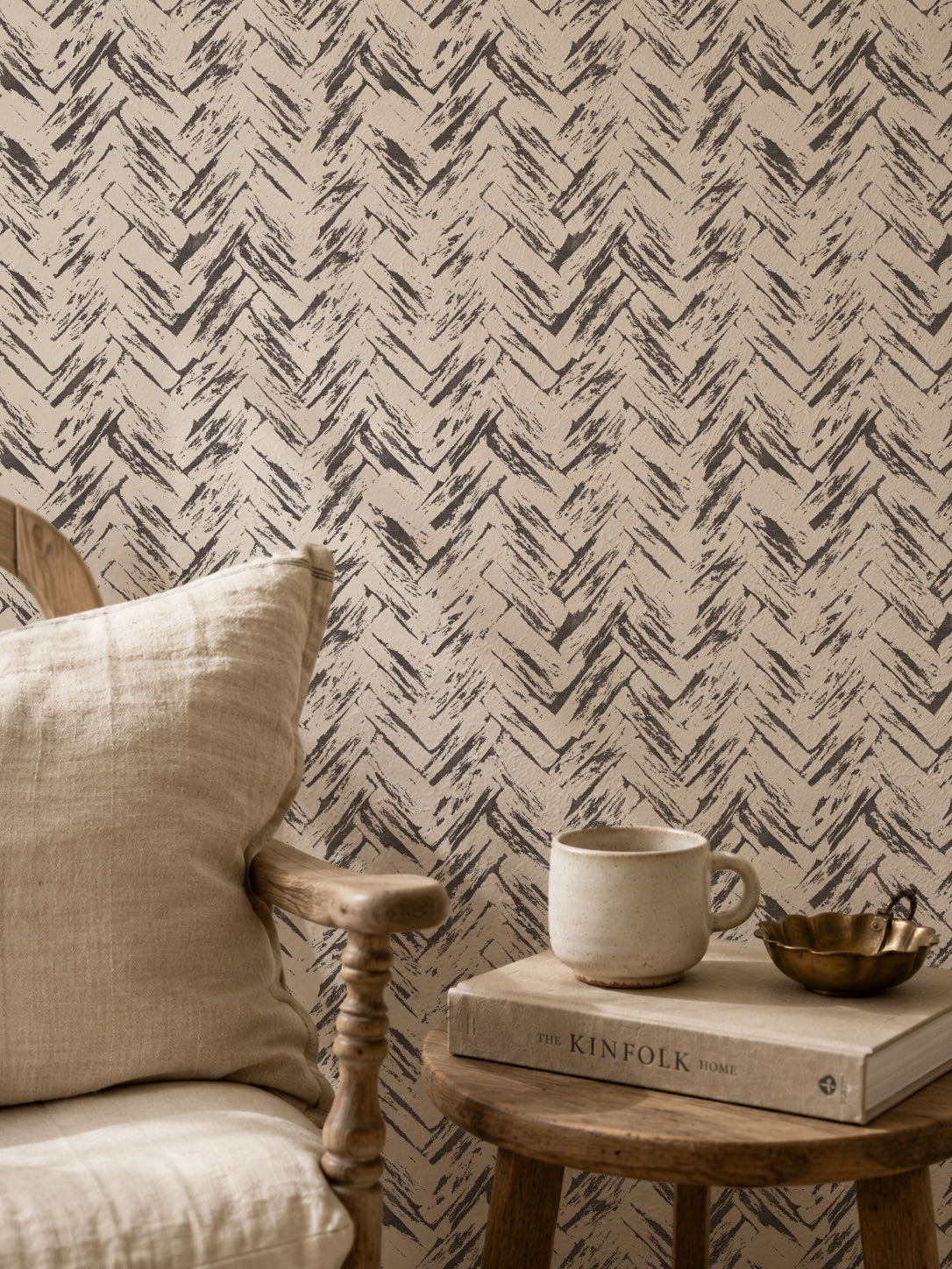 Rustic chevron wallpaper in cream and charcoal with chair and table setting.