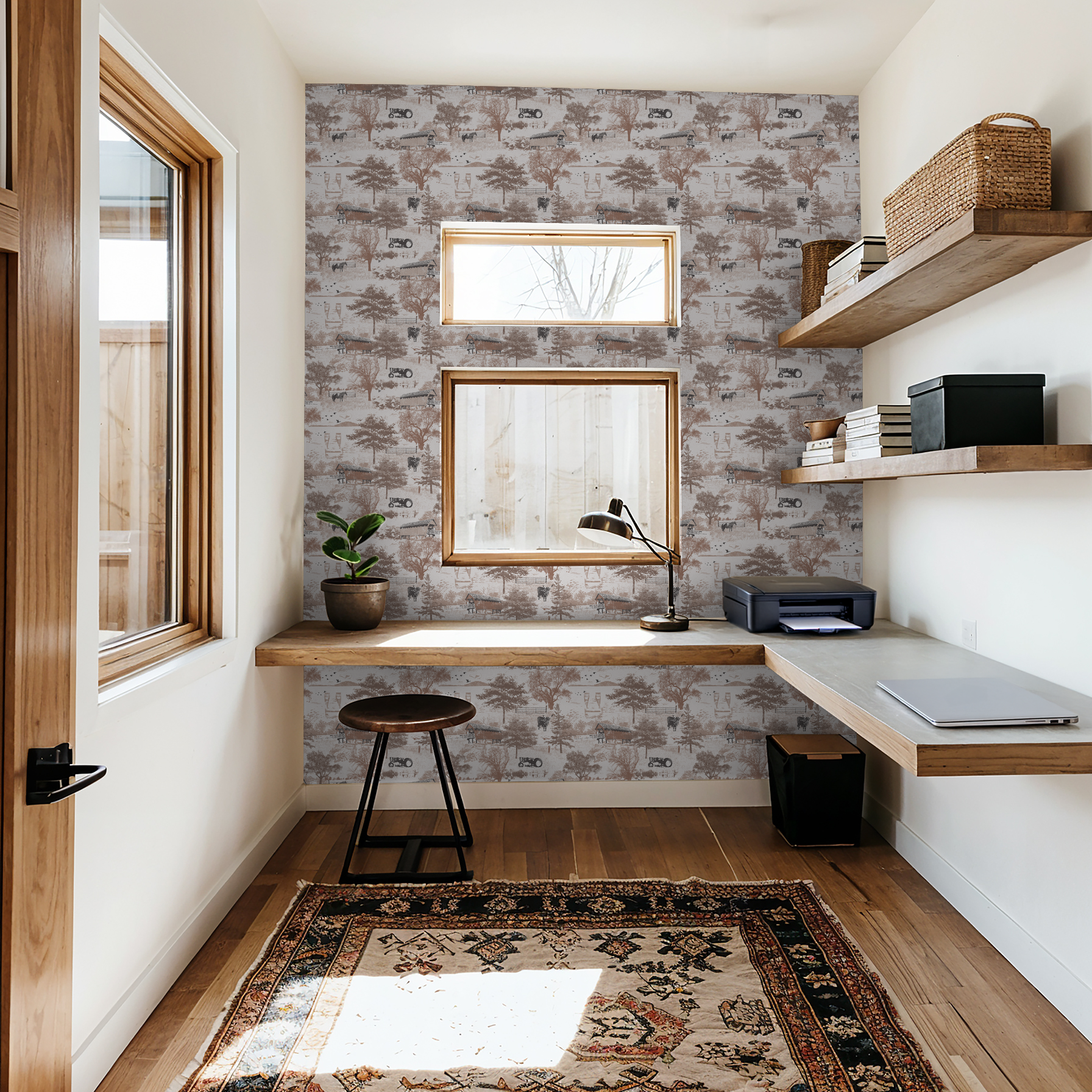Rustic countryside toile wallpaper with barns and trees in a cozy study room.
