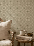 Sage botanical lattice wallpaper in cozy living room with wooden chair and table.