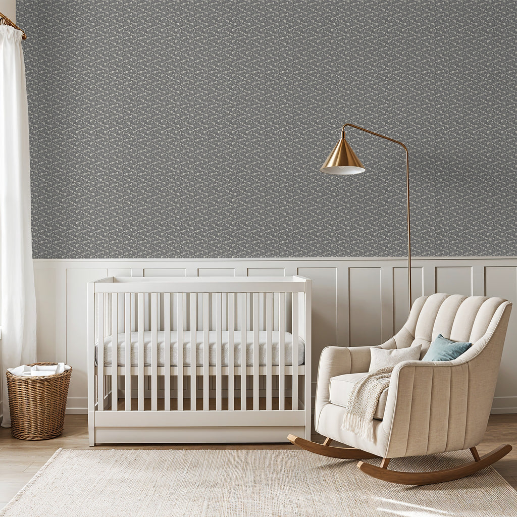 Slate floral wallpaper in a serene nursery with white crib and beige rocking chair.