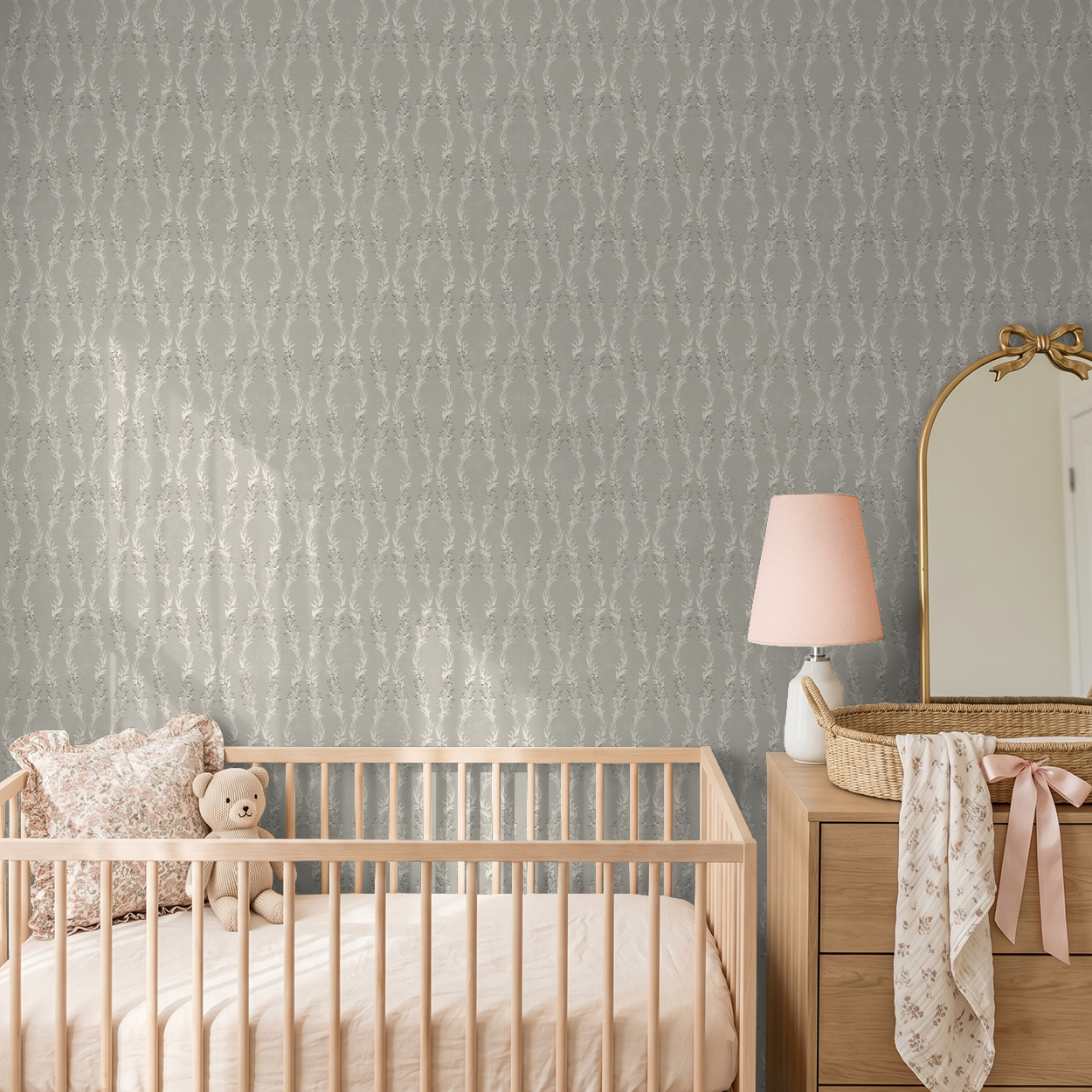 Stone floral garland wallpaper in nursery with crib and dresser.