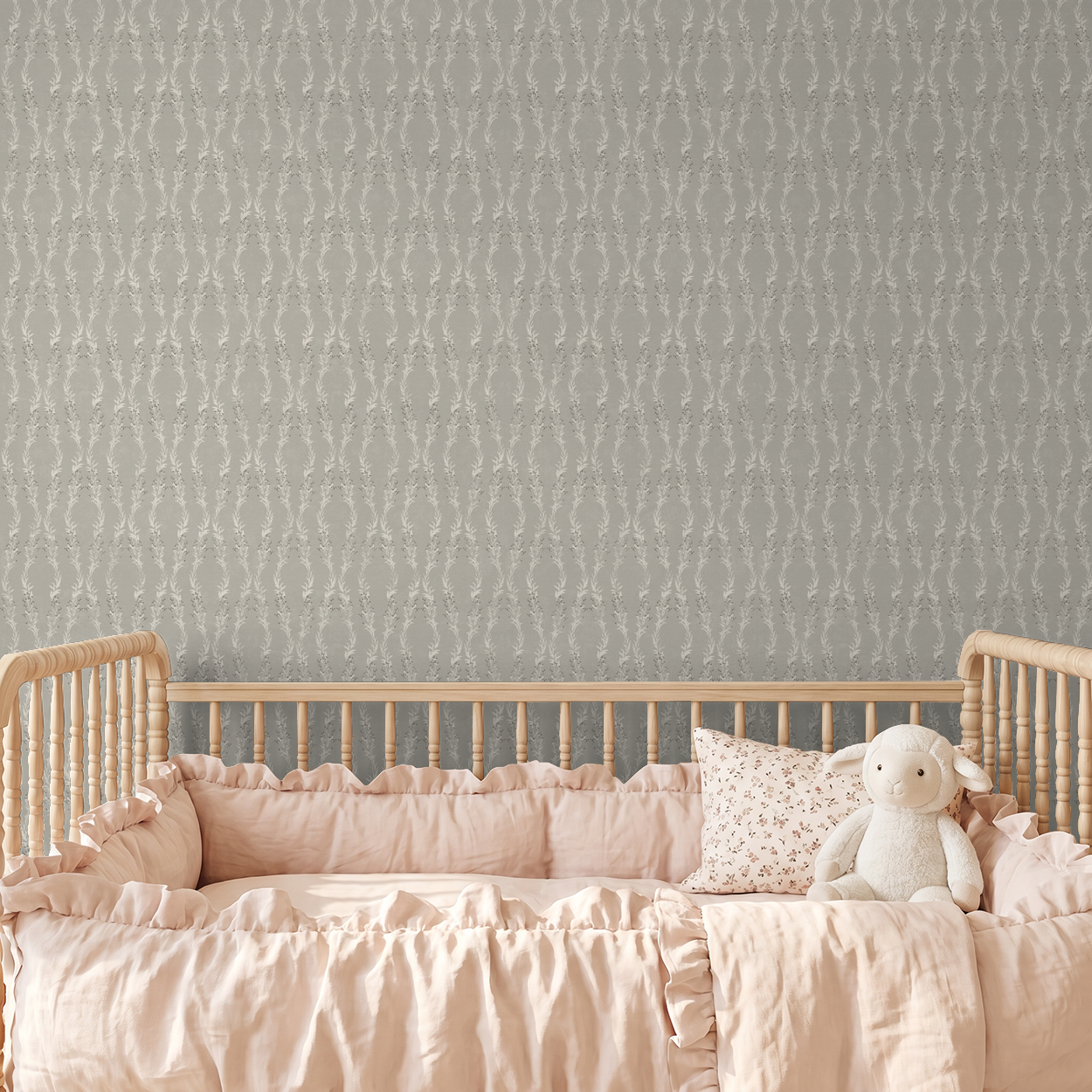 Stone floral garland wallpaper in nursery with wooden crib and pink bedding.