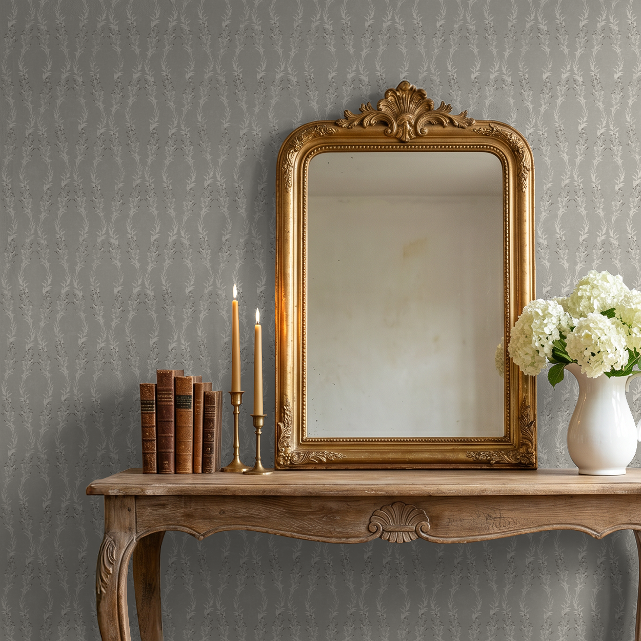 Stone floral wallpaper with leafy garlands in elegant room with mirror and wooden table.