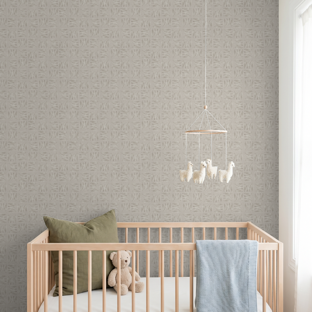 Stone leaf pattern wallpaper in a nursery with crib and teddy bear.
