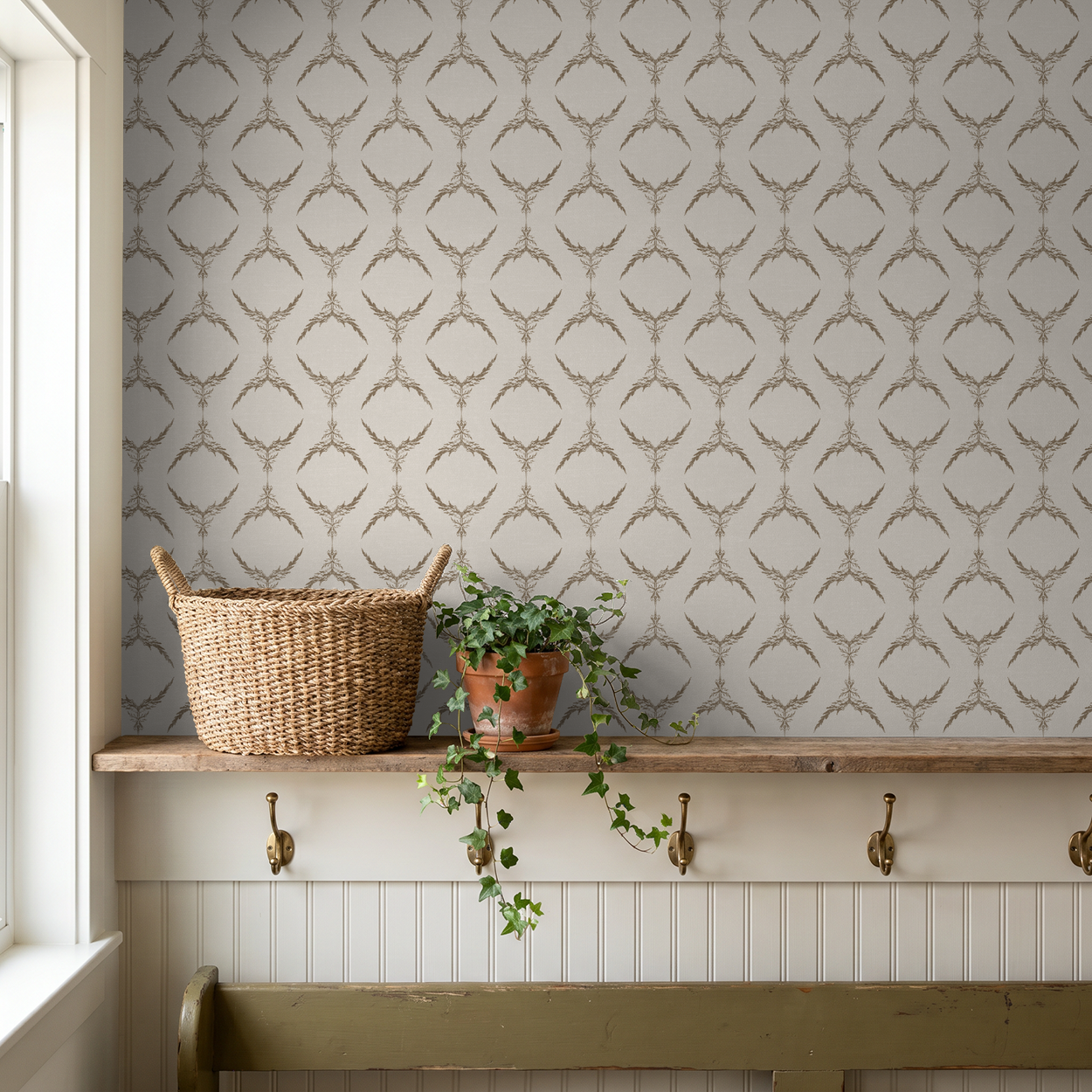 Taupe botanical medallion wallpaper in rustic entryway with basket and plant.