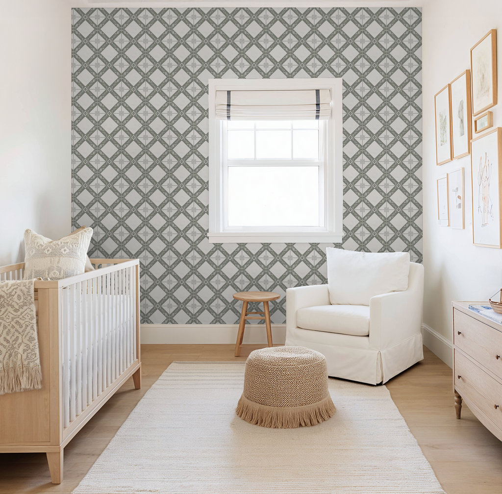 Nursery with taupe botanical trellis wallpaper, crib, chair, and decor.