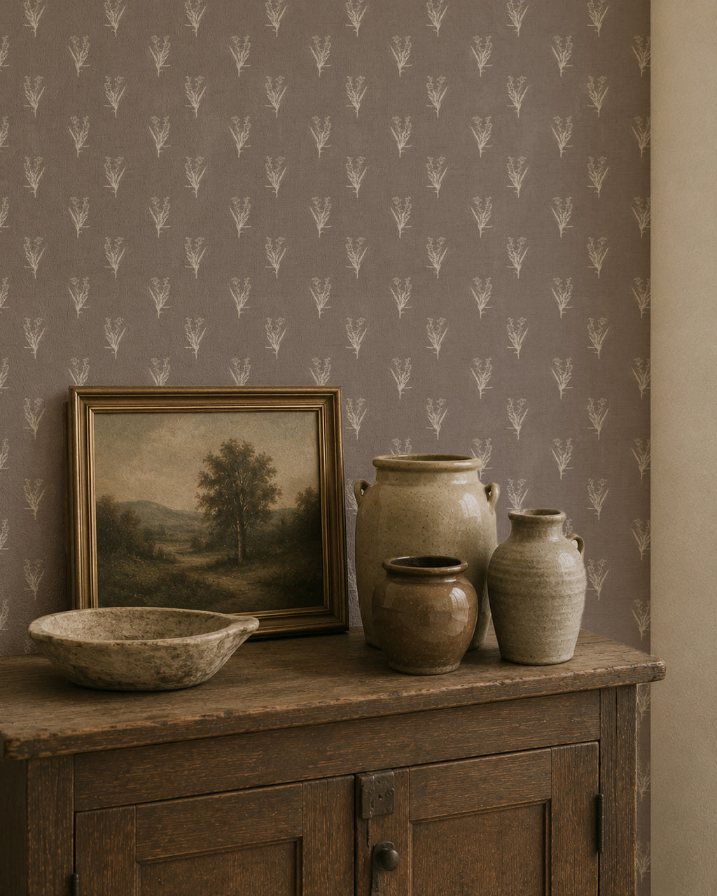 Taupe wallpaper with ivory botanical motifs in rustic room setting.