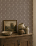 Taupe wallpaper with ivory botanical motifs in rustic room setting.
