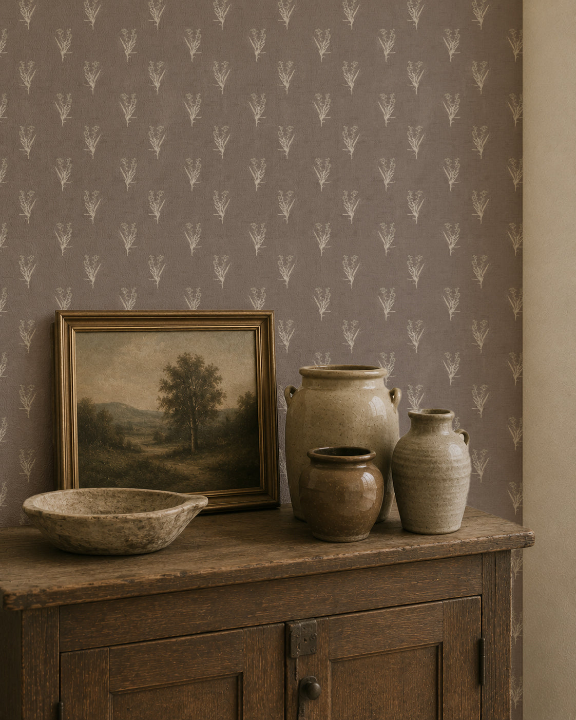 Taupe wallpaper with ivory botanical motifs in rustic room setting.