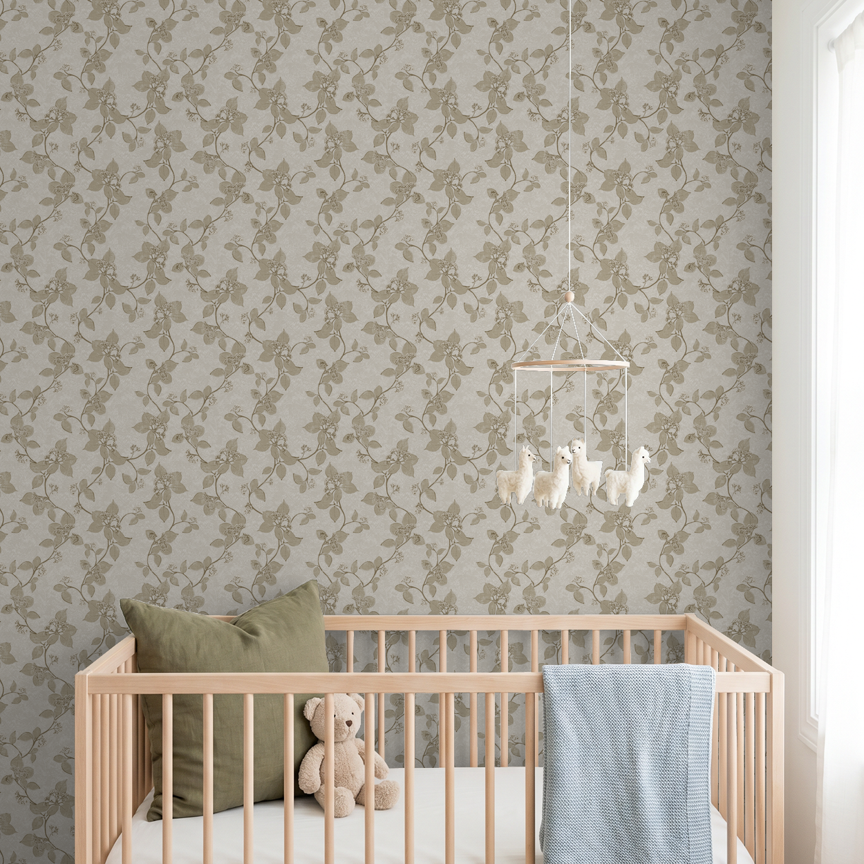 Taupe floral vine wallpaper in serene nursery with crib and teddy bear.