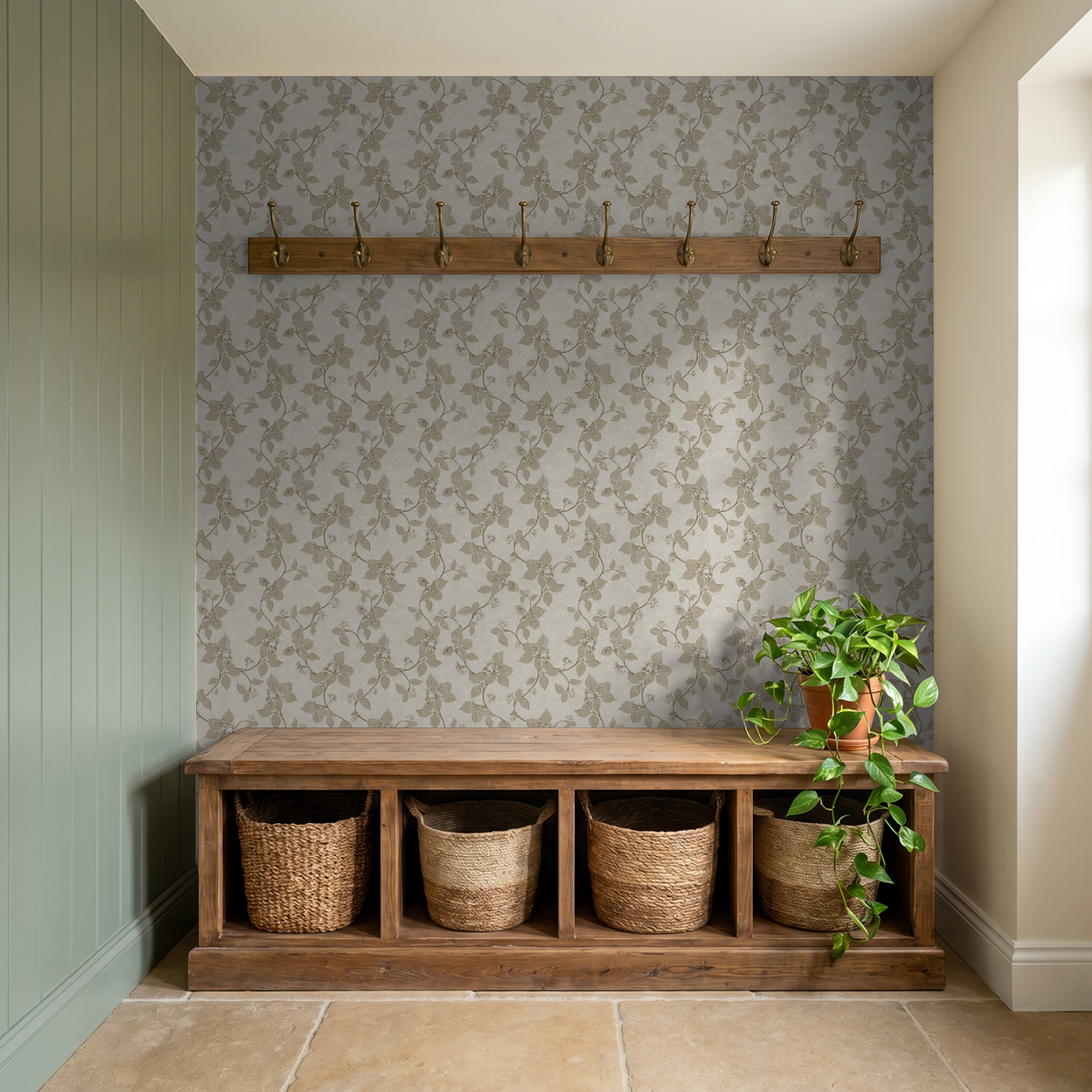Taupe floral vine wallpaper in a rustic entryway with wooden bench and coat hooks.