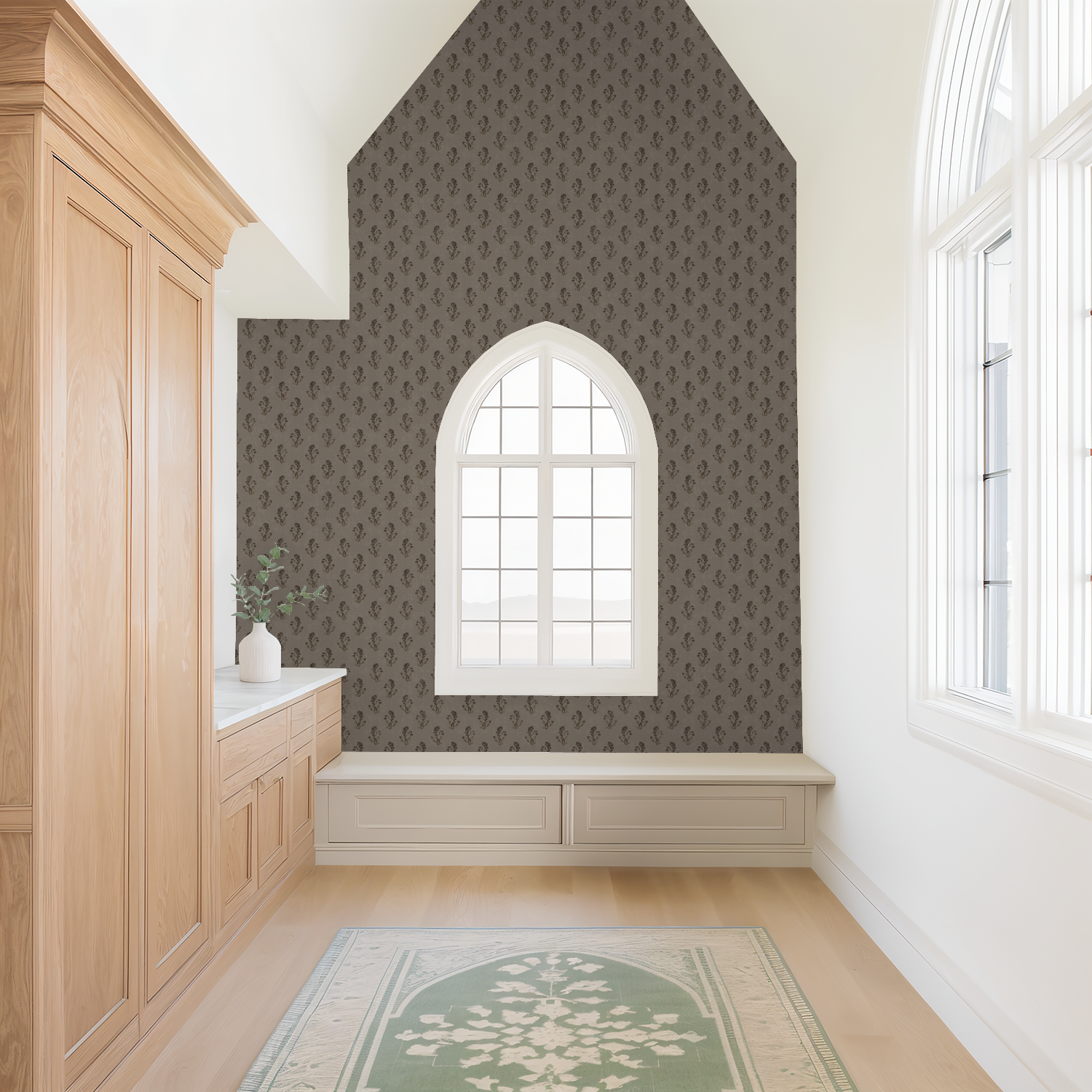 Taupe floral wallpaper with delicate motifs in a bright room with arched window.