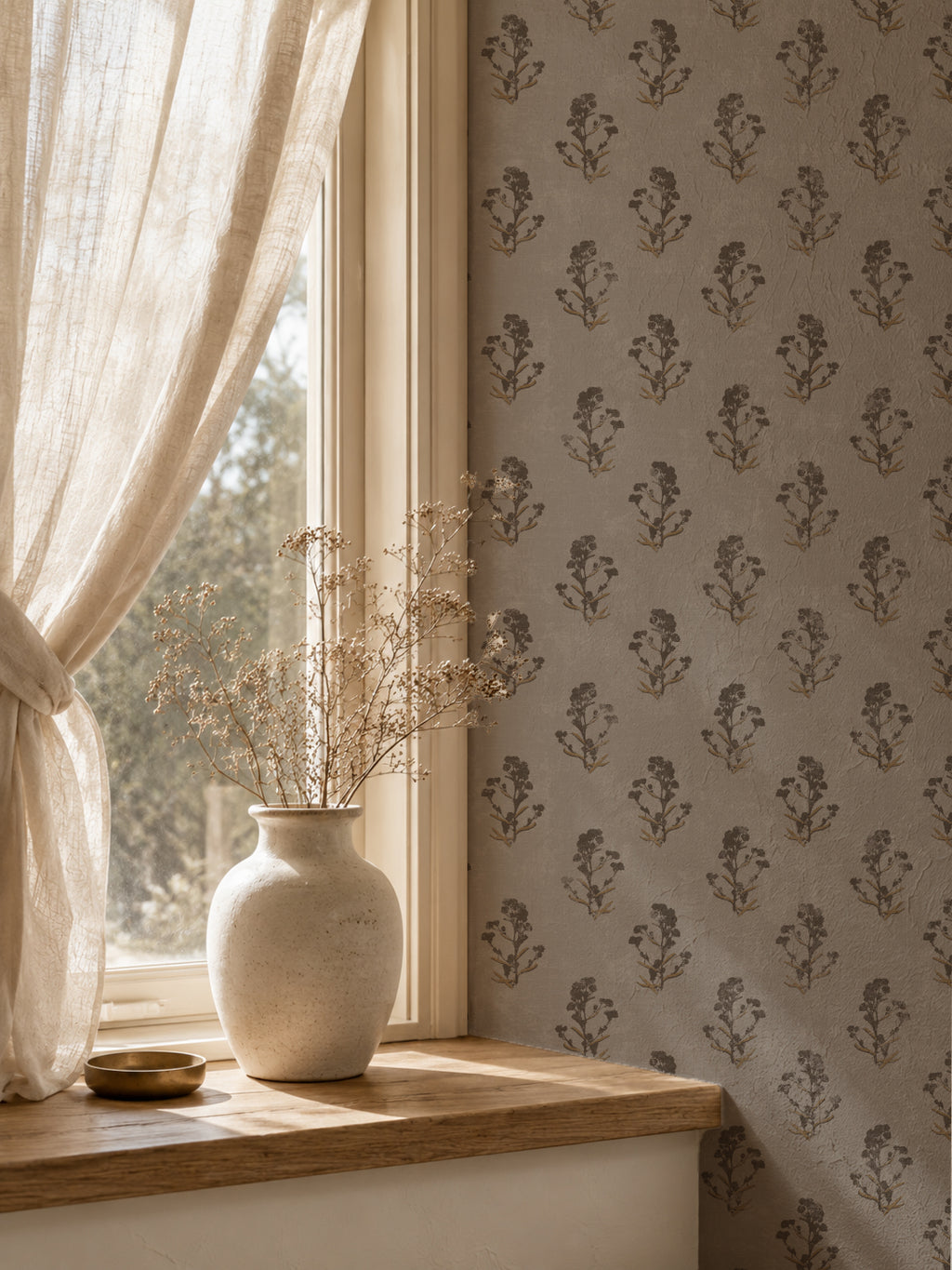 Taupe floral wallpaper with delicate brown motifs in a cozy room setting.