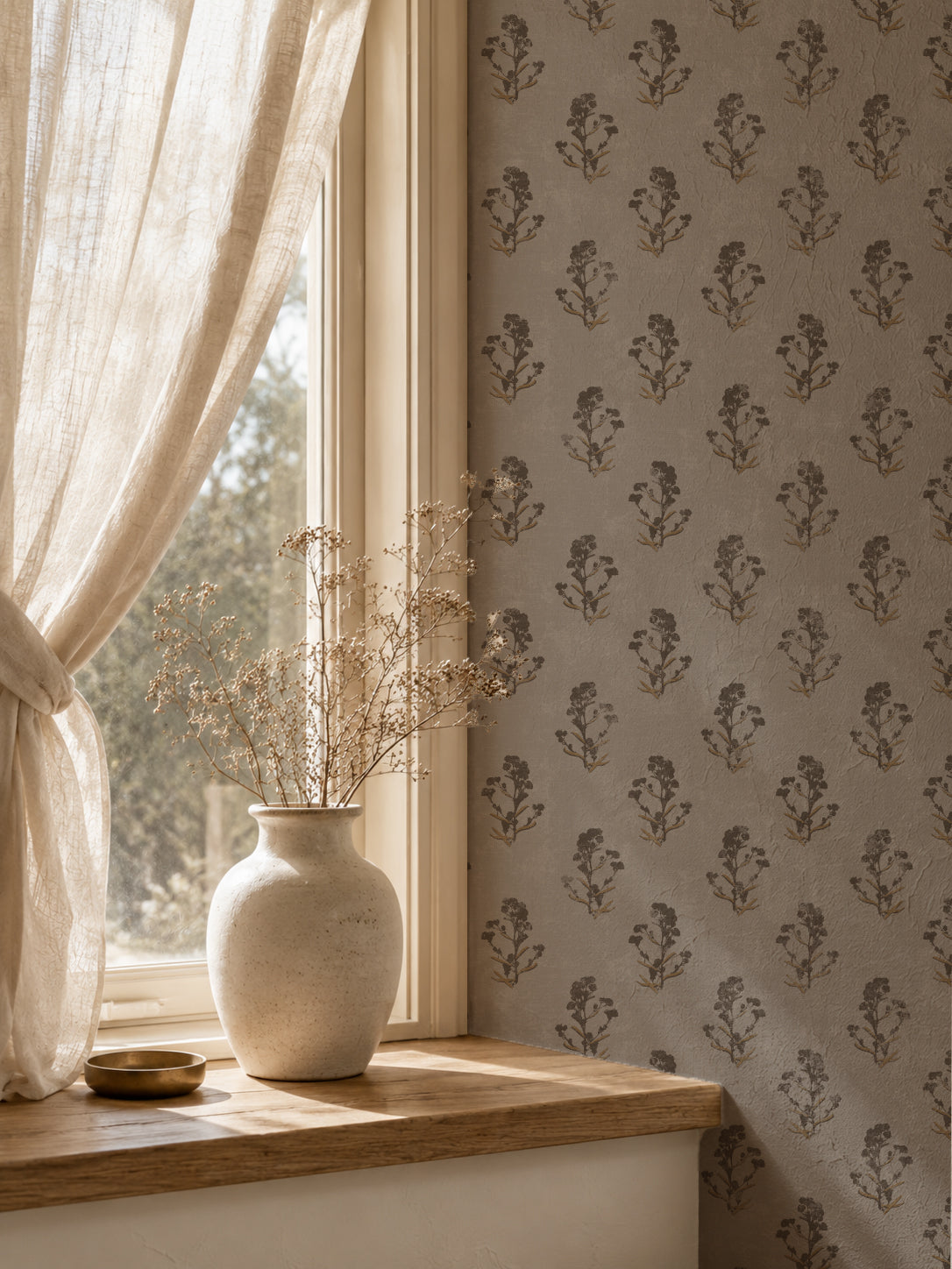 Taupe floral wallpaper with delicate brown motifs in a cozy room setting.