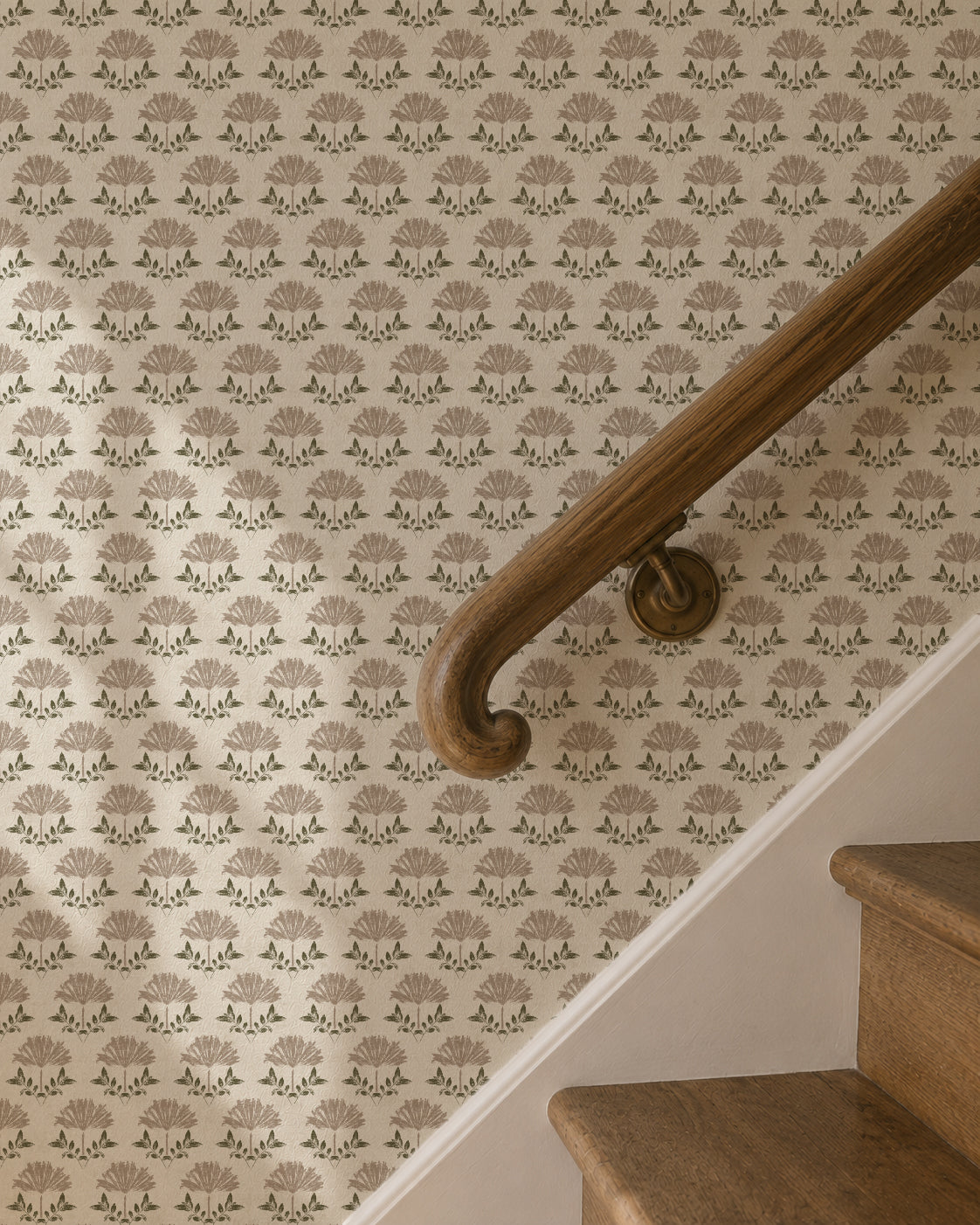 Taupe floral wallpaper with cream background on staircase wall, rustic style.