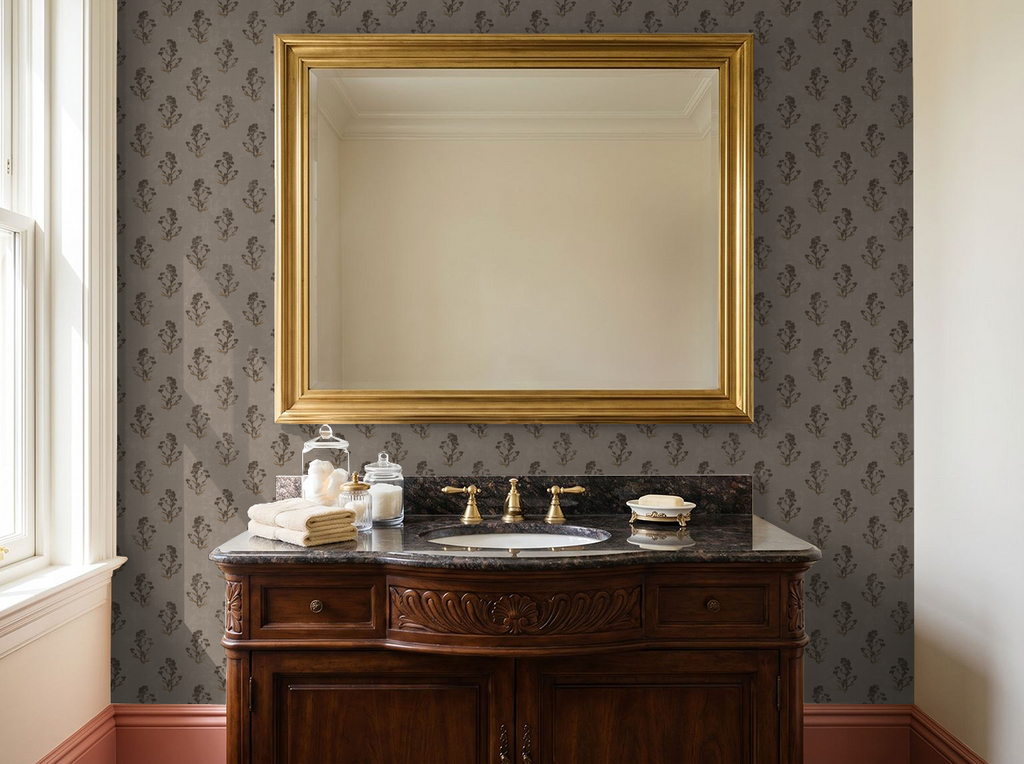Taupe floral wallpaper in elegant bathroom with gold mirror and wooden vanity.