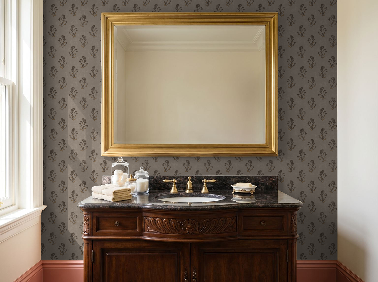Taupe floral wallpaper in elegant bathroom with gold mirror and wooden vanity.