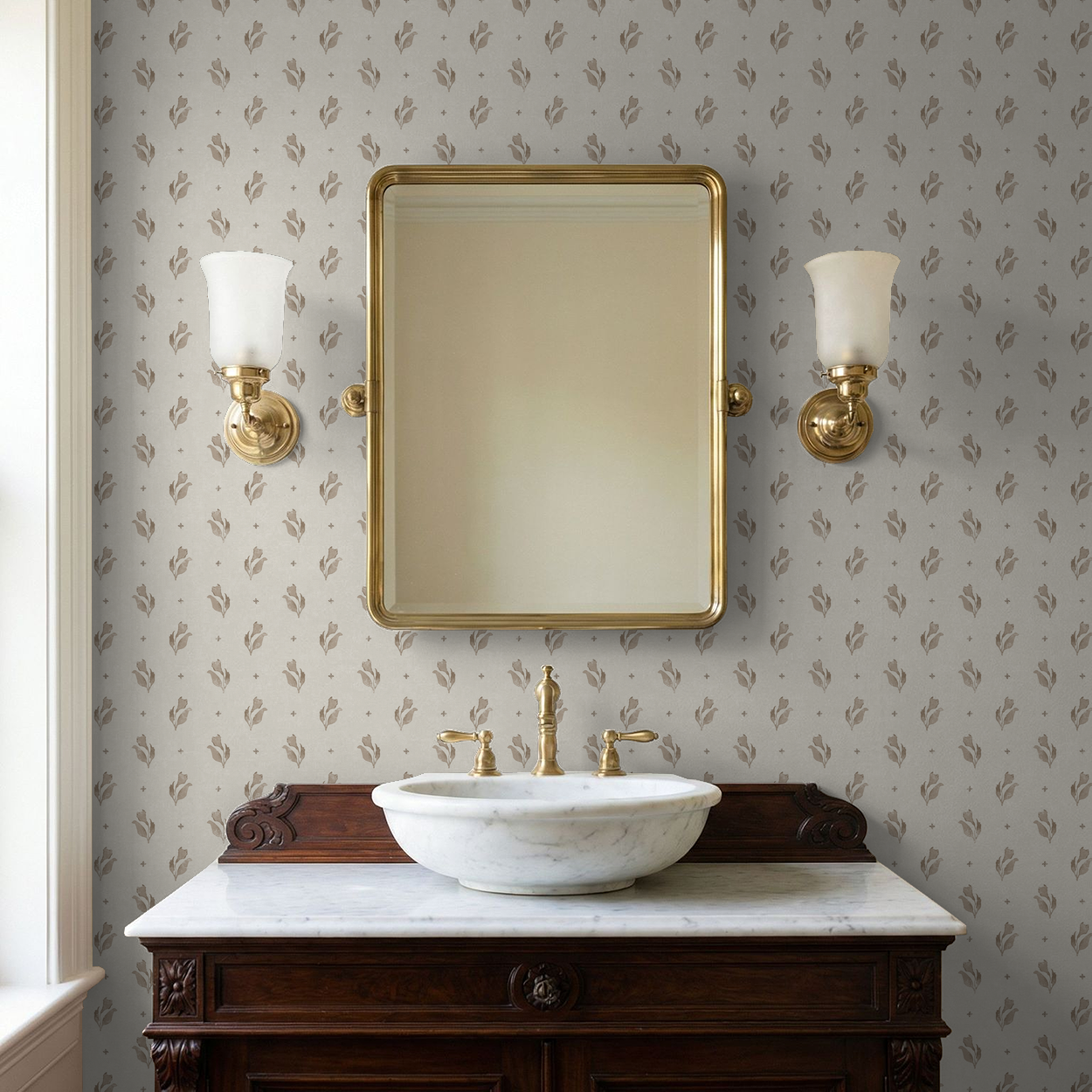 Taupe floral wallpaper in elegant bathroom with gold mirror and fixtures.