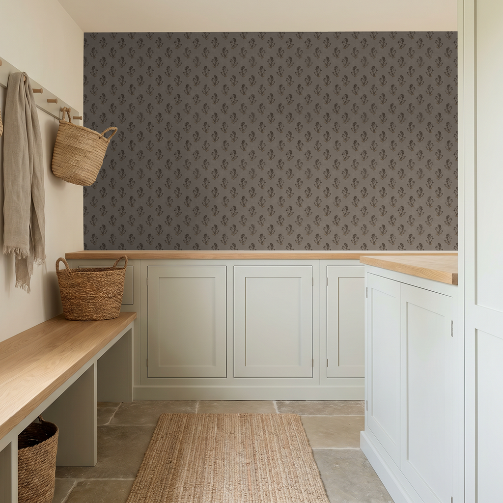 Taupe floral wallpaper in a rustic mudroom with wicker baskets and wooden bench.