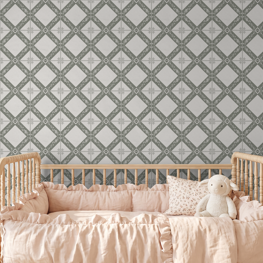Taupe geometric floral wallpaper in nursery with wooden crib and pink bedding