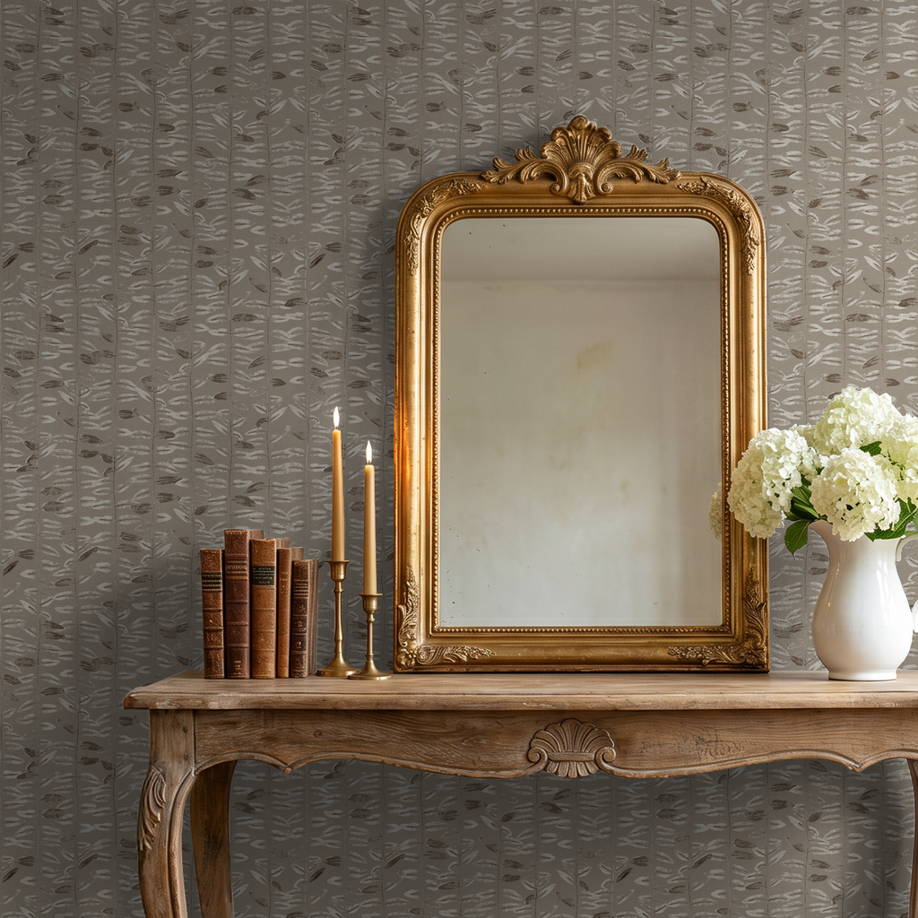 Taupe olive branch wallpaper in rustic room with ornate mirror and flowers.