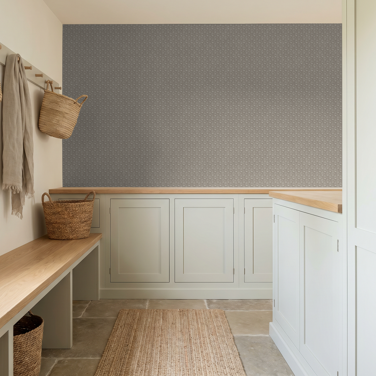 Taupe vine patterned wallpaper in a modern mudroom with beige cabinets.