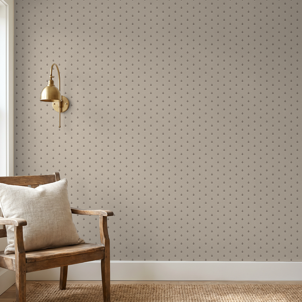 Vintage block print wallpaper in oatmeal with delicate motif in cozy room setting.