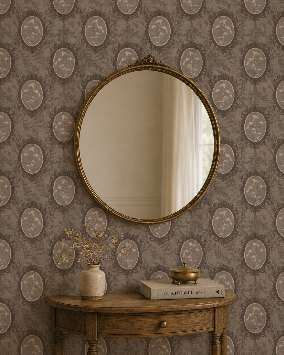 Vintage floral cameo wallpaper in brown tones with mirror and wooden table decor.
