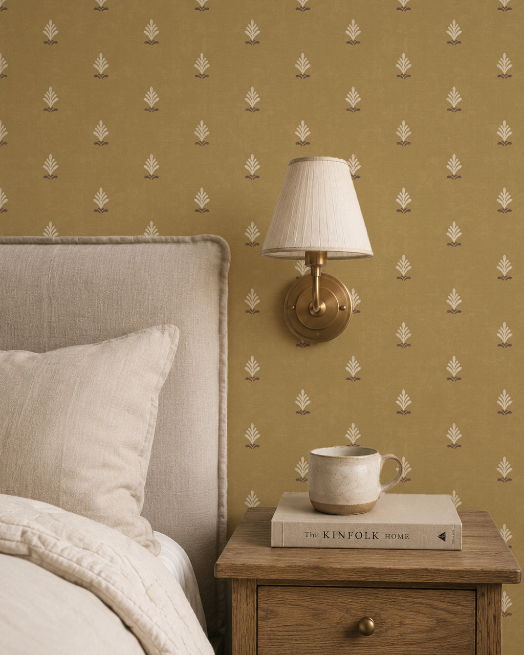 Vintage ochre wallpaper with cream motifs in cozy bedroom setting.