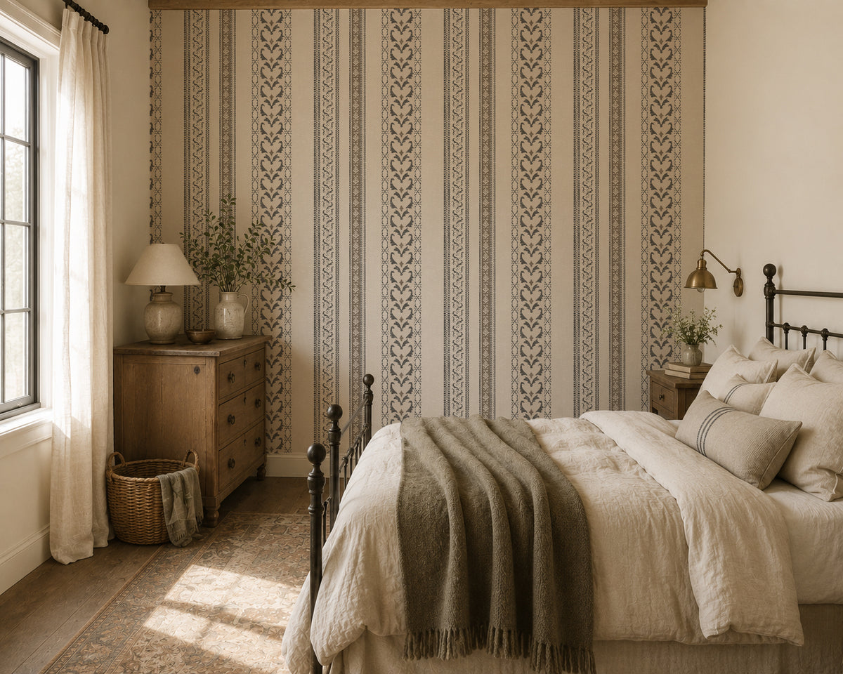 Vintage ornamental stripe wallpaper in taupe and charcoal in cozy bedroom setting.