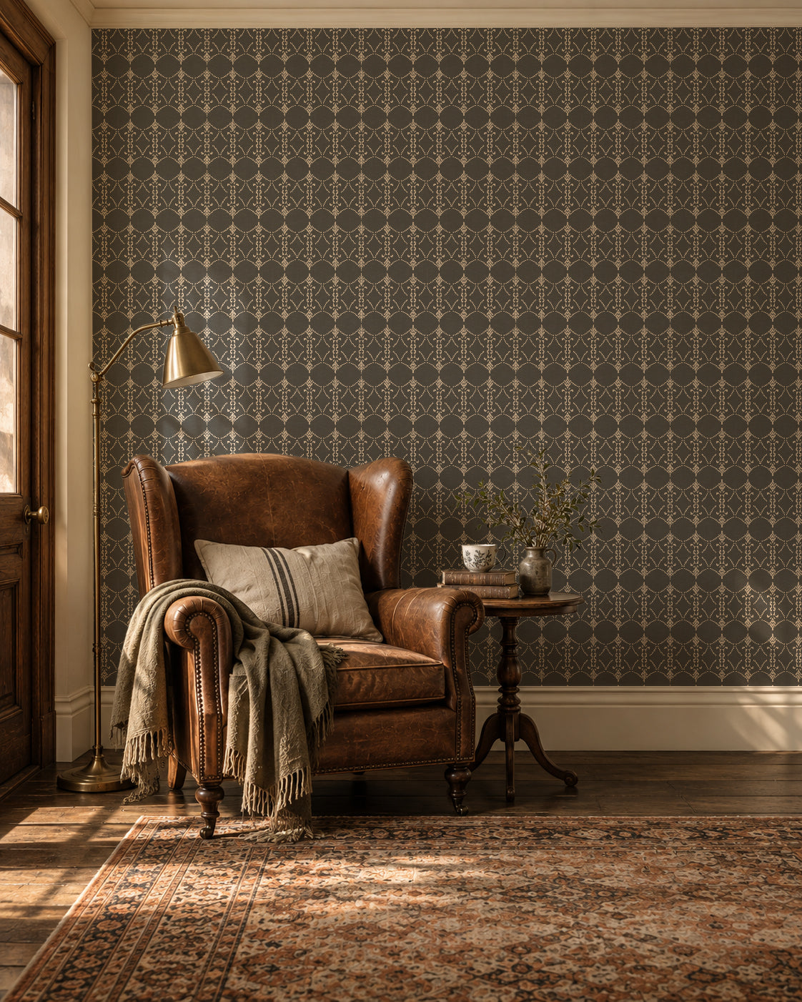 Vintage ornamental trellis charcoal wallpaper in cozy living room with leather chair and side table.