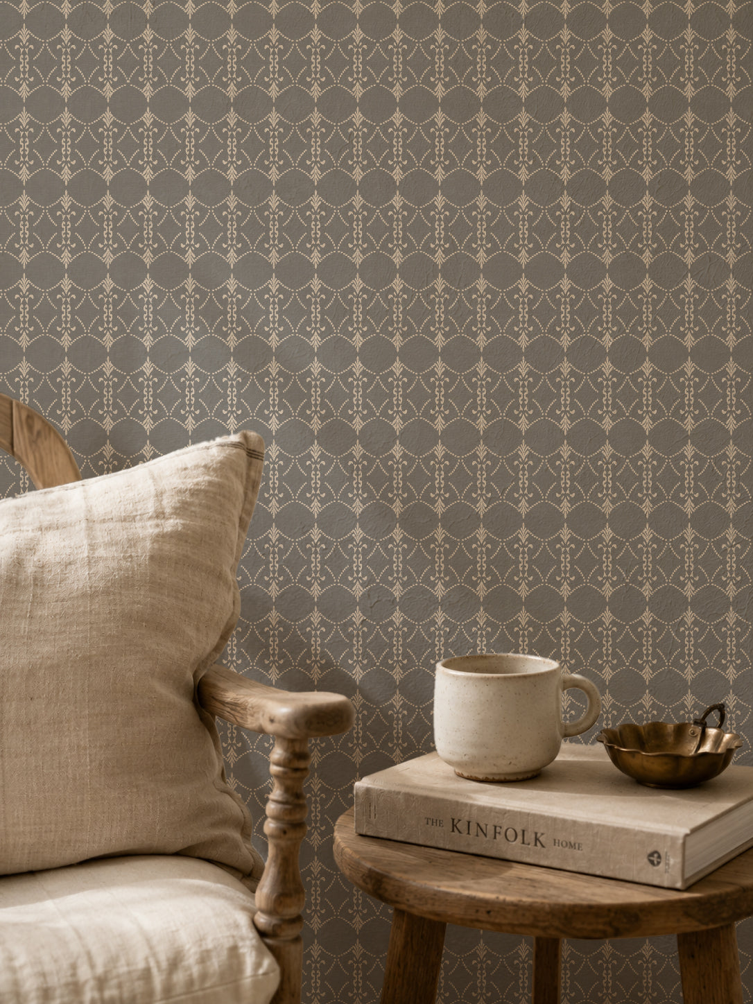 Vintage ornamental trellis wallpaper in grey and cream with chair and table setting.