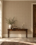 Vintage taupe and ivory trellis wallpaper in elegant entryway with wooden console.